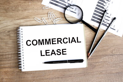 Image of a notepad with the words commercial lease signifying commercial leasing