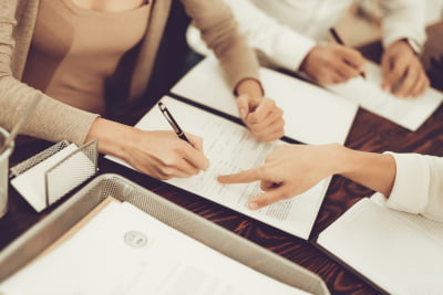 Image of a couple signing documents for their house sale