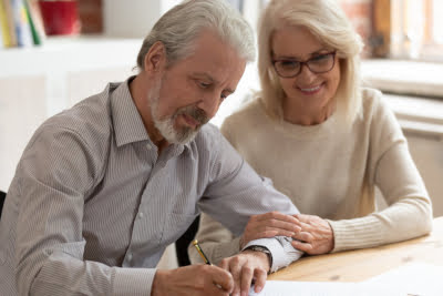 Photo of a couple signing a Will